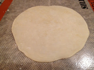 rolled out tortilla dough