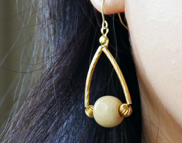 closeup of wooden bead dangle earrings