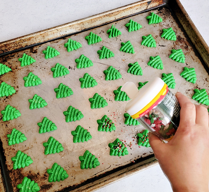 Decorating classic spritz cookies with sprinkles