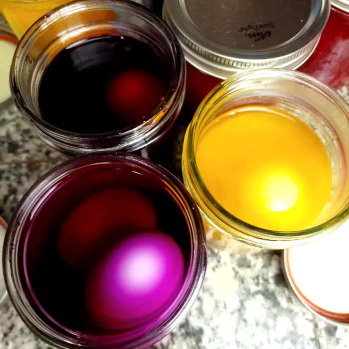 Add natural egg dye into jars with eggs