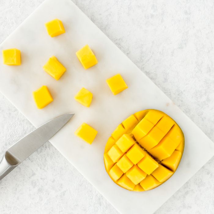 Cube fresh mango for topping the mangonada