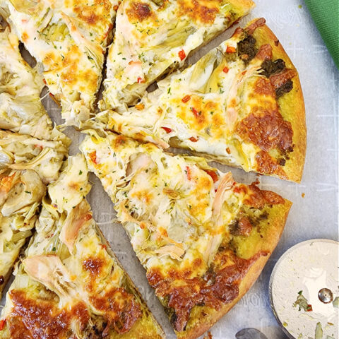 Sliced artichoke chicken pesto pizza