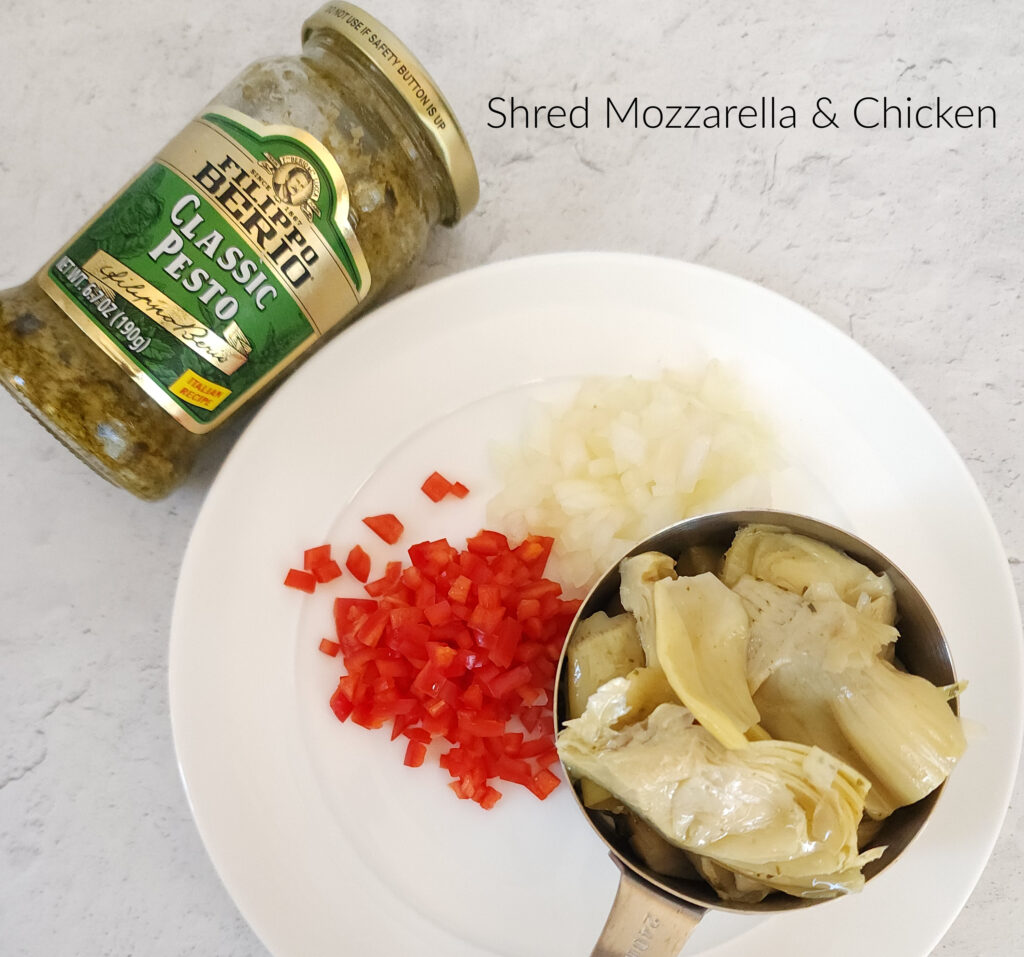 Prep the ingredients for the artichoke chicken pesto pizza
