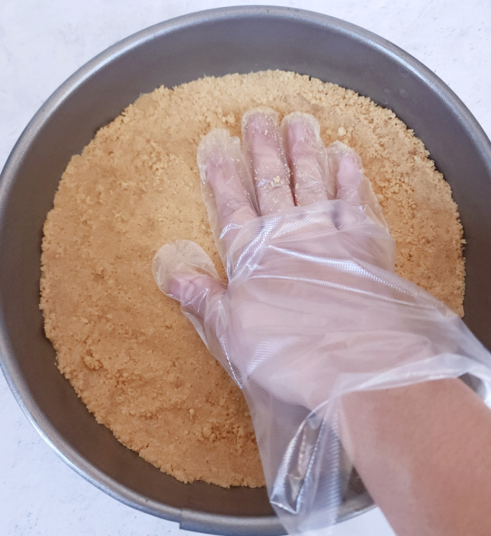 Press shortbread crumbs to form cake crust.