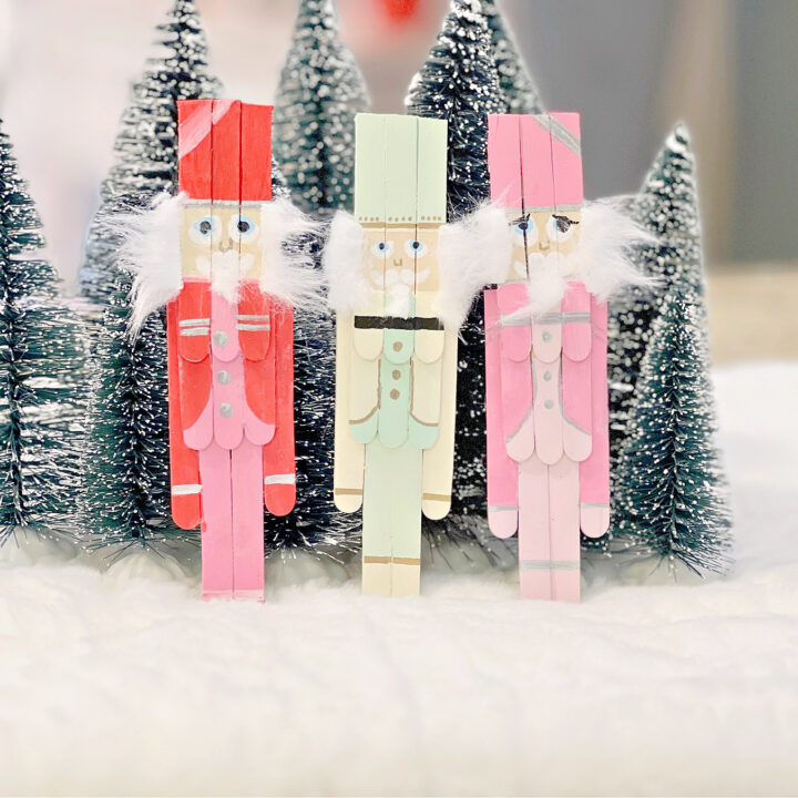 Popsicle Stick Nutcrackers in front of trees.