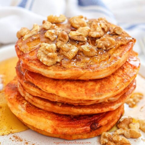 Pumpkin pancakes with maple syrup and walnuts.